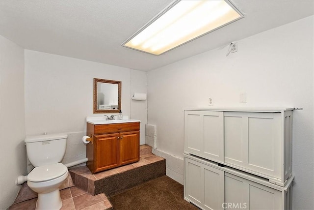 145 Cumberland Dr, Lake Arrowhead, CA 92352 - bathroom with toilet, vanity, and tile patterned flooring