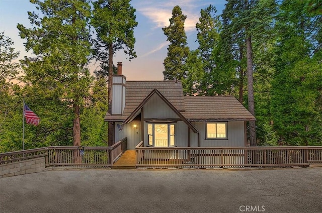 145 Cumberland Dr, Lake Arrowhead, CA 92352 - view of front of home with a chimney and a wooden deck