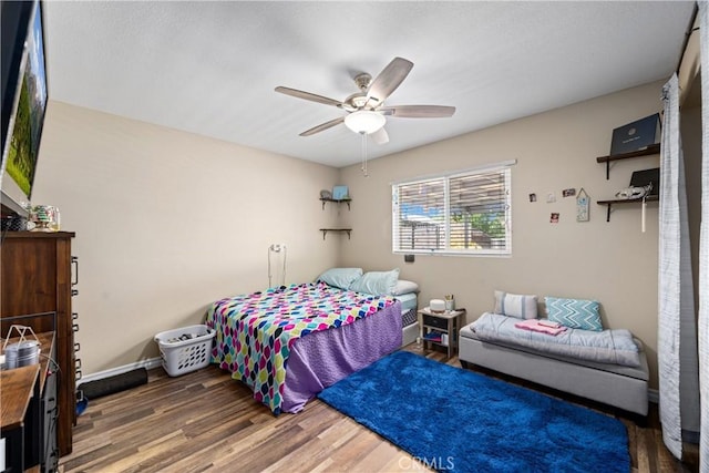 19927 Athenon Ave, Perris, CA 92570 - bedroom with wood finished floors, a ceiling fan, and baseboards