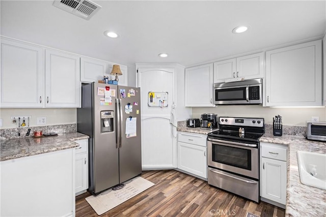 19927 Athenon Ave, Perris, CA 92570 - kitchen featuring stainless steel appliances, dark wood-style floors, white cabinets, recessed lighting, and a sink