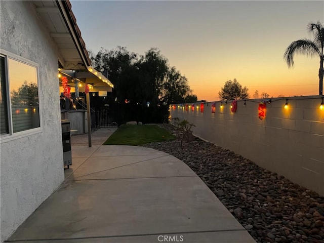19927 Athenon Ave, Perris, CA 92570 - yard at dusk with a patio area and a fenced backyard