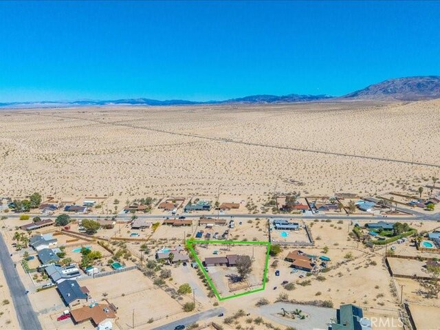 4689 Stirrup Ln Unit 29, Palms, CA 92277 - overview of rural landscape featuring a desert landscape, a mountain backdrop, and property boundaries highlighted
