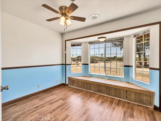 4689 Stirrup Ln Unit 29, Palms, CA 92277 - unfurnished room with wood finished floors, a ceiling fan, and baseboards