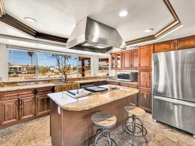 4689 Stirrup Ln Unit 29, Palms, CA 92277 - kitchen featuring stainless steel appliances, island range hood, a sink, a center island, and ornamental molding