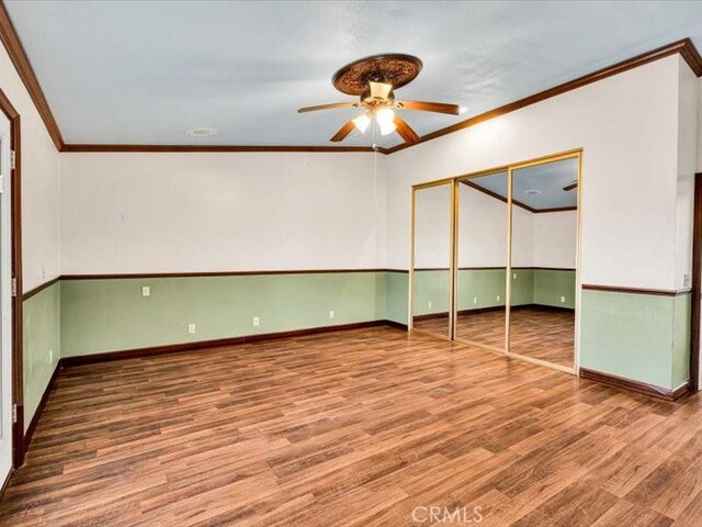 4689 Stirrup Ln Unit 29, Palms, CA 92277 - unfurnished bedroom with wood finished floors, ornamental molding, baseboards, a closet, and a ceiling fan