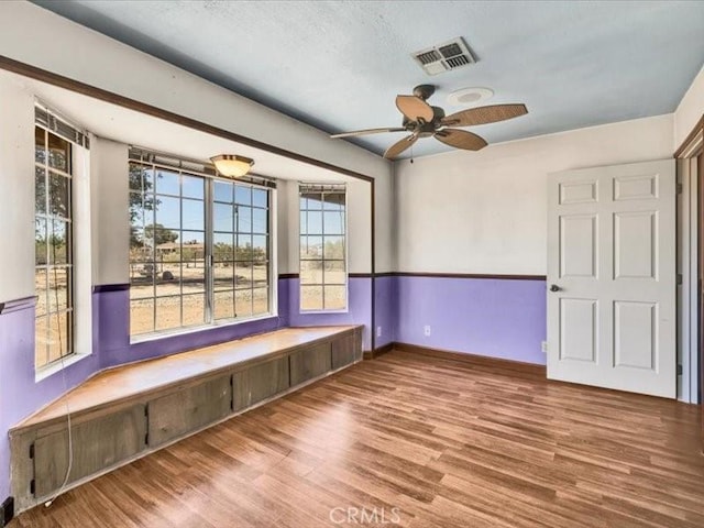 4689 Stirrup Ln Unit 29, Palms, CA 92277 - spare room featuring wood finished floors, a ceiling fan, and baseboards