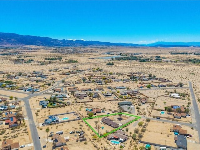 4689 Stirrup Ln Unit 29, Palms, CA 92277 - aerial view of sparsely populated area with property boundaries highlighted, a desert landscape, and mountains