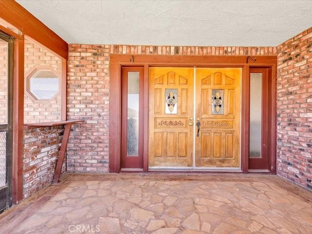 4689 Stirrup Ln Unit 29, Palms, CA 92277 - entrance to property with brick siding and a porch