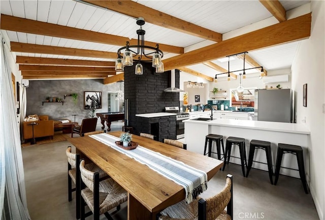 60515 Alta Loma Dr, Joshua Tree, CA 92252 - dining room with finished concrete floors, beam ceiling, and a chandelier