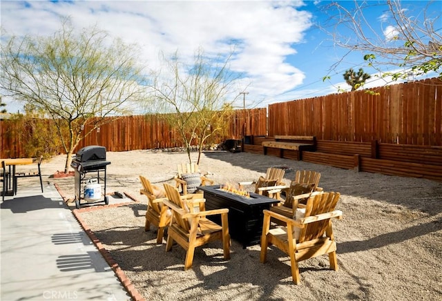 60515 Alta Loma Dr, Joshua Tree, CA 92252 - view of patio / terrace featuring a fire pit, a fenced backyard, and a grill