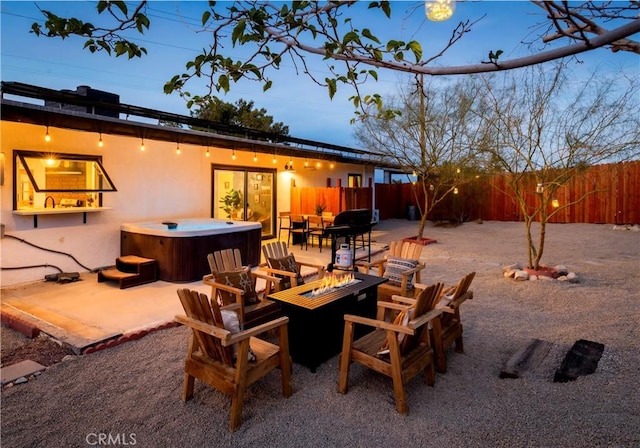 60515 Alta Loma Dr, Joshua Tree, CA 92252 - view of patio / terrace with a hot tub, an outdoor fire pit, and a fenced backyard