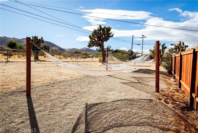 60515 Alta Loma Dr, Joshua Tree, CA 92252 - view of yard featuring fence and a mountain view