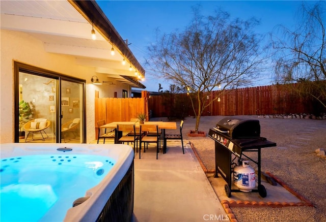 60515 Alta Loma Dr, Joshua Tree, CA 92252 - view of patio featuring a fenced backyard, outdoor dining area, a hot tub, and a grill