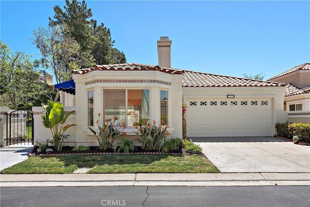 28412 Buena Vis, Mission Viejo, CA 92692 - mediterranean / spanish-style home featuring a garage, driveway, a tiled roof, stucco siding, and a gate