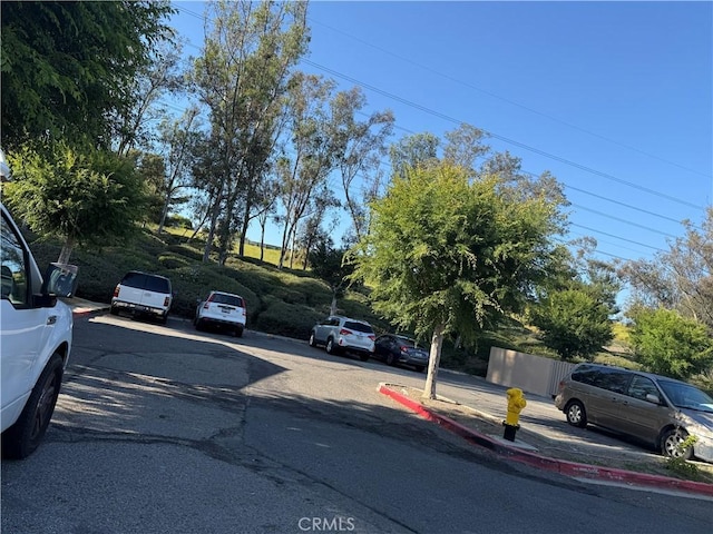 25779 Via Lomas Unit 170, Laguna Hills, CA 92653 - view of asphalt road featuring curbs