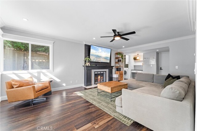 1421 Woodcrest Ave, Brea, CA 92821 - living room with dark wood-type flooring, ornamental molding, a lit fireplace, a ceiling fan, and washer / dryer