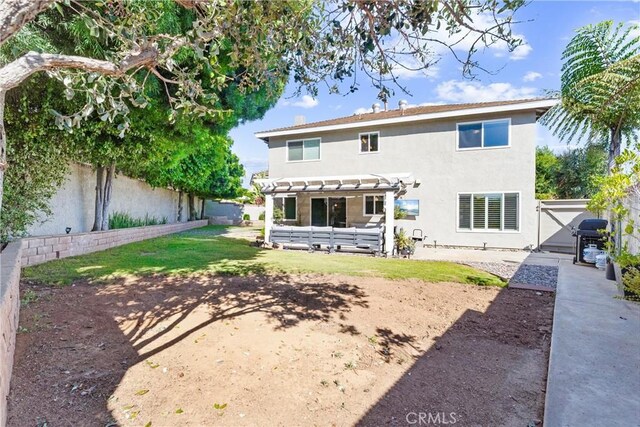 1421 Woodcrest Ave, Brea, CA 92821 - rear view of property featuring a fenced backyard, a pergola, stucco siding, and a patio