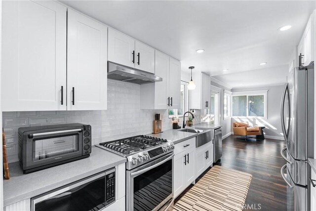 1421 Woodcrest Ave, Brea, CA 92821 - kitchen with appliances with stainless steel finishes, under cabinet range hood, a sink, backsplash, and baseboards