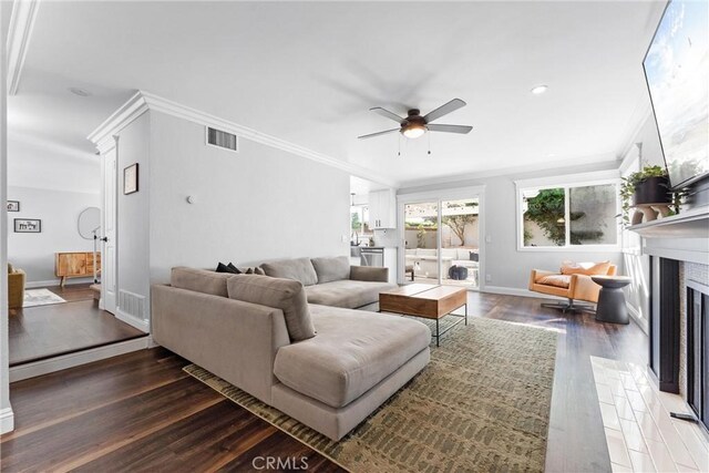 1421 Woodcrest Ave, Brea, CA 92821 - living room featuring a ceiling fan, wood finished floors, crown molding, a fireplace with flush hearth, and baseboards
