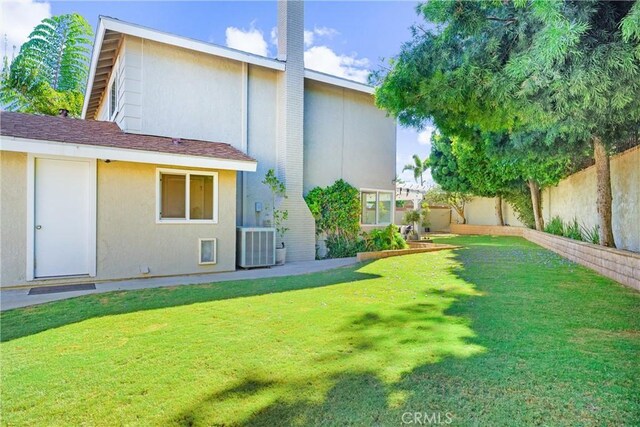 1421 Woodcrest Ave, Brea, CA 92821 - rear view of property featuring central air condition unit, stucco siding, and a chimney