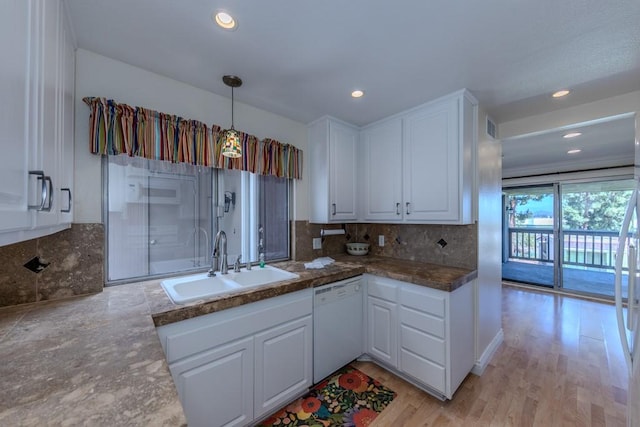 23342 Caminito Juanico Unit 304, Laguna Hills, CA 92653 - kitchen with white dishwasher, white cabinets, tasteful backsplash, recessed lighting, and dark countertops