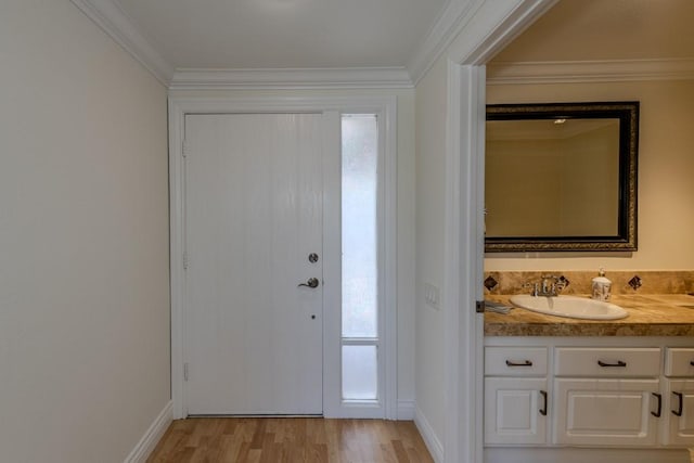 23342 Caminito Juanico Unit 304, Laguna Hills, CA 92653 - entryway with light wood-style flooring, plenty of natural light, crown molding, and bar with sink