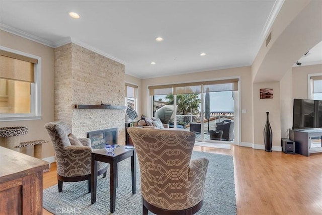 723 N Lucia Ave Unit A, Redondo Beach, CA 90277 - living area featuring plenty of natural light, crown molding, light wood-style flooring, a stone fireplace, and recessed lighting