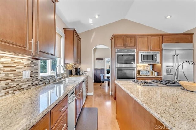 723 N Lucia Ave Unit A, Redondo Beach, CA 90277 - kitchen with a sink, built in appliances, lofted ceiling, light stone countertops, and light wood-type flooring