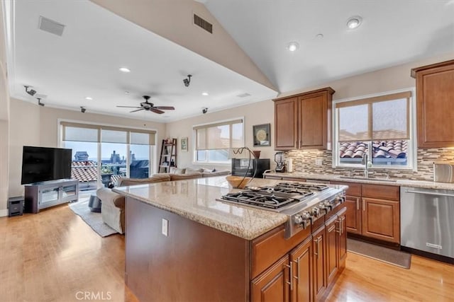 723 N Lucia Ave Unit A, Redondo Beach, CA 90277 - kitchen featuring a sink, stainless steel appliances, light wood-style flooring, brown cabinets, and a kitchen island