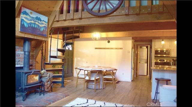 33020 Arrowbear, Running Springs, CA 92382 - dining room with a wood stove, wood finished floors, and stairway