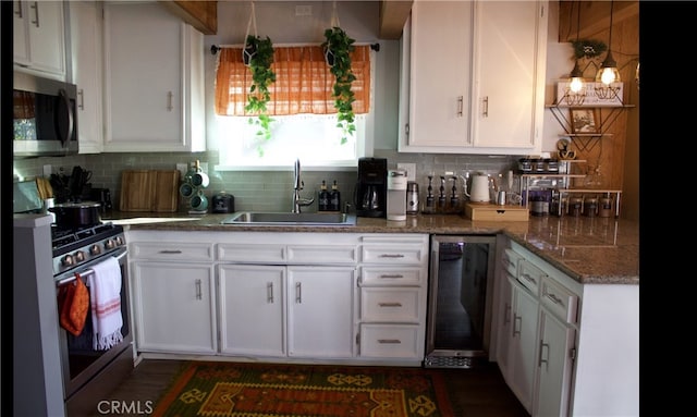 33020 Arrowbear, Running Springs, CA 92382 - kitchen featuring stainless steel appliances, a sink, white cabinetry, and decorative backsplash