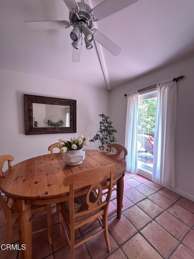 dining room with lofted ceiling, ceiling fan, and baseboards
