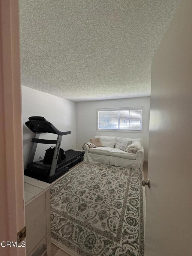 workout room featuring a textured ceiling