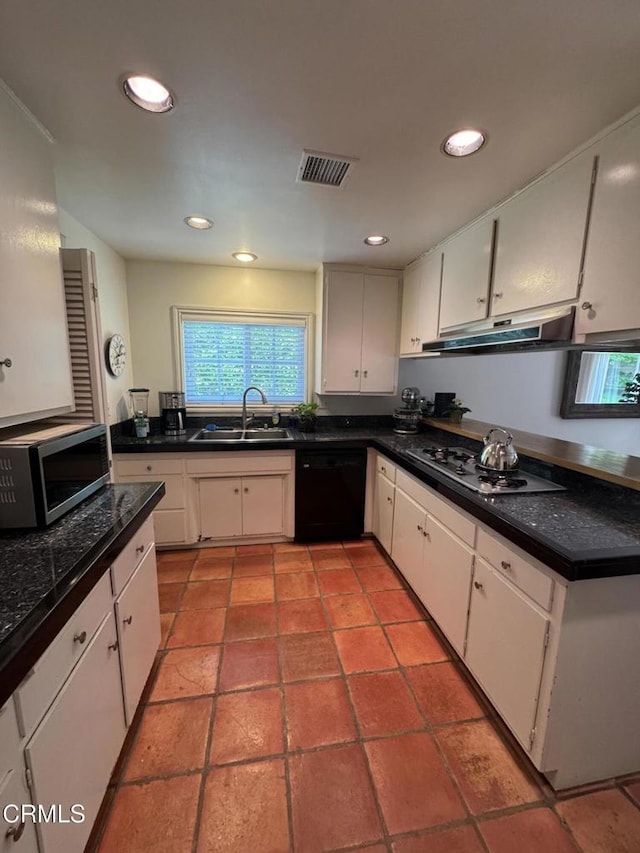 kitchen featuring stainless steel microwave, under cabinet range hood, a sink, black dishwasher, and cooktop