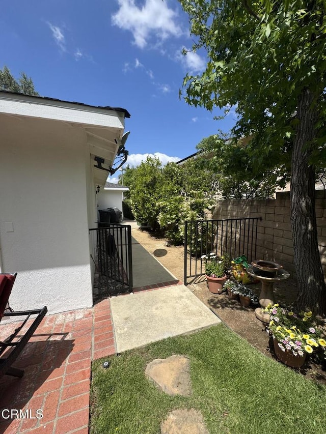 view of yard with fence and a patio
