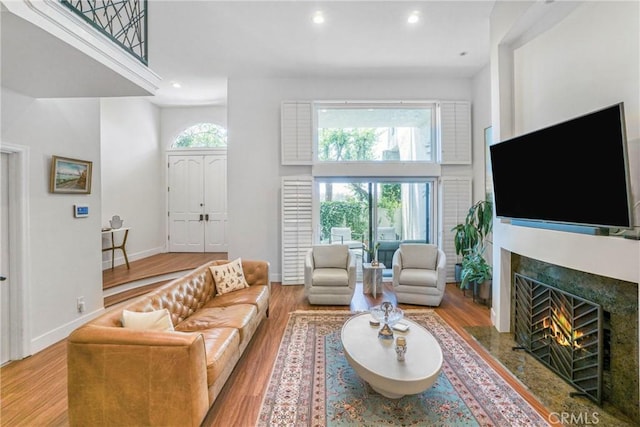 2311 Roscomare Rd Unit 16, Los Angeles, CA 90077 - living area with wood finished floors, a fireplace, recessed lighting, and a high ceiling