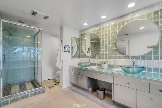 2311 Roscomare Rd Unit 16, Los Angeles, CA 90077 - bathroom with double vanity, a shower stall, tasteful backsplash, and recessed lighting