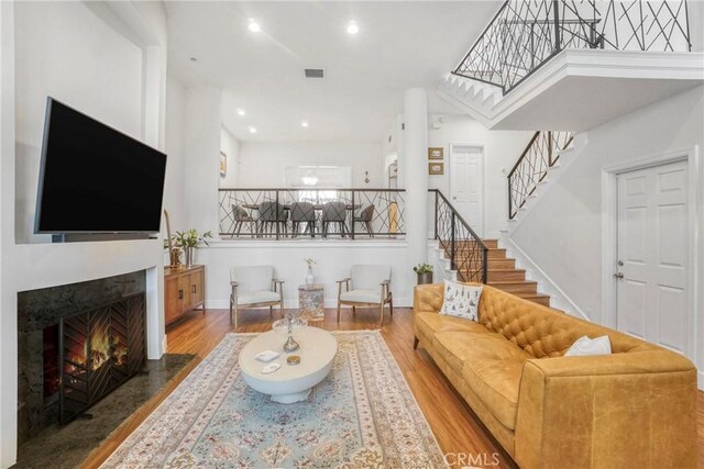 2311 Roscomare Rd Unit 16, Los Angeles, CA 90077 - living room with wood finished floors, stairs, a fireplace with flush hearth, and recessed lighting
