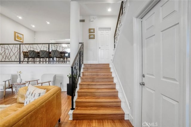 2311 Roscomare Rd Unit 16, Los Angeles, CA 90077 - staircase with wood finished floors and recessed lighting