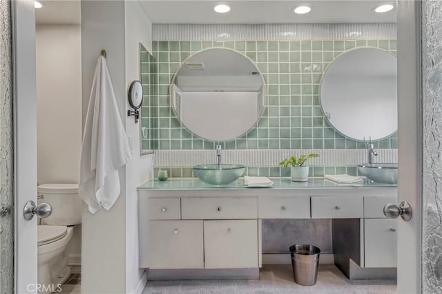 2311 Roscomare Rd Unit 16, Los Angeles, CA 90077 - full bathroom featuring double vanity, recessed lighting, tile walls, and tasteful backsplash