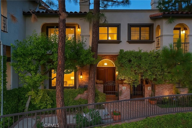 2311 Roscomare Rd Unit 16, Los Angeles, CA 90077 - mediterranean / spanish house with a tile roof, stucco siding, and a chimney