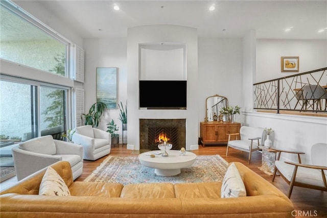 2311 Roscomare Rd Unit 16, Los Angeles, CA 90077 - living area with wood finished floors, a warm lit fireplace, and recessed lighting
