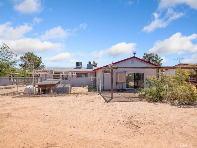 14060 Osage Rd, Apple Valley, CA 92307 - rear view of house featuring fence, stucco siding, and a chimney