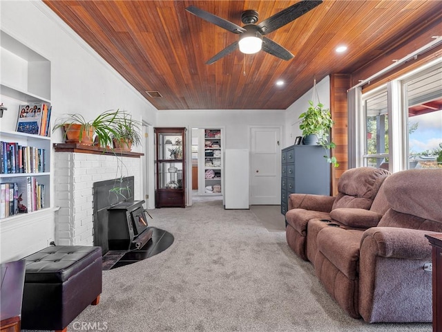 14060 Osage Rd, Apple Valley, CA 92307 - carpeted living room featuring wood ceiling, ceiling fan, a wood stove, and recessed lighting