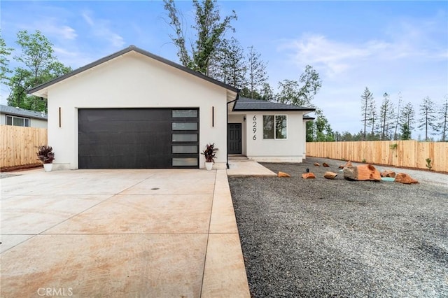 6296 Diamond Ave, Paradise, CA 95969 - view of front facade with stucco siding, concrete driveway, fence, and an attached garage