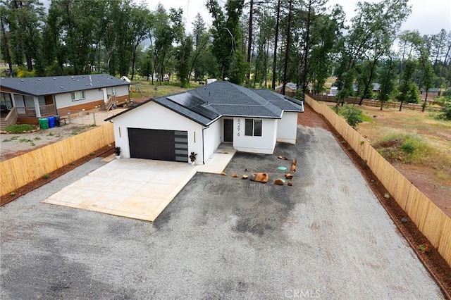 6296 Diamond Ave, Paradise, CA 95969 - view of front facade with driveway, a garage, stucco siding, fence, and a shingled roof