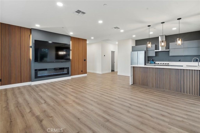 6296 Diamond Ave, Paradise, CA 95969 - unfurnished living room with recessed lighting, light wood-type flooring, a sink, and baseboards