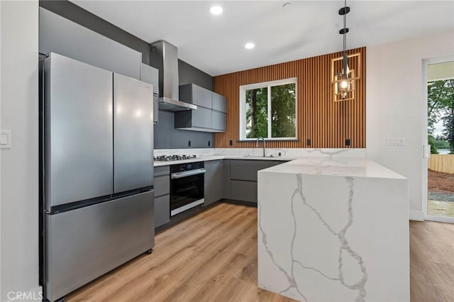 6296 Diamond Ave, Paradise, CA 95969 - kitchen with appliances with stainless steel finishes, wall chimney range hood, gray cabinets, light stone countertops, and a peninsula