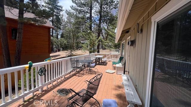 33421 Wild Rose Dr, Green Valley Lake, CA 92341 - wooden terrace with outdoor dining area