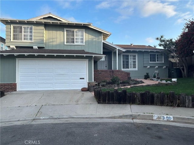 990 244th St, Harbor City, CA 90710 - view of front of property featuring concrete driveway, an attached garage, and brick siding